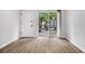Bright living room with wood-look floors, sliding glass doors, and white trim at 1225 Church St # A, Decatur, GA 30030