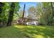 Home's backyard with deck, mature trees and lush landscaping at 1585 San Gabriel Ave, Decatur, GA 30032