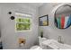 Well-lit bathroom showcasing a vanity with modern fixtures, a toilet, and a window offering natural light at 1585 San Gabriel Ave, Decatur, GA 30032