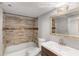 Bright bathroom featuring a tiled shower/tub combo and a vanity with modern fixtures, combining style and functionality at 1585 San Gabriel Ave, Decatur, GA 30032