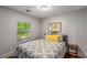 Cozy bedroom featuring a window view, a comfortable bed, and stylish decor at 1585 San Gabriel Ave, Decatur, GA 30032