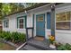 Charming front door with teal paint, brick, and landscaping at 1585 San Gabriel Ave, Decatur, GA 30032