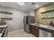 Contemporary kitchen featuring stainless steel appliances, subway tile backsplash, and ample storage at 1585 San Gabriel Ave, Decatur, GA 30032