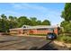 The Kirkwood Library is a brick building with a modern, barrel vaulted roof and ample parking spaces at 1585 San Gabriel Ave, Decatur, GA 30032