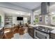 Bright living room flowing into modern kitchen with hardwood floors, and stylish decor at 1585 San Gabriel Ave, Decatur, GA 30032