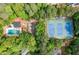 Aerial view featuring pool, tennis courts, and community amenities nestled among lush greenery at 2144 Lamplight Dr, Marietta, GA 30062