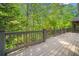 Expansive back deck with wooden railing, providing a great view of the wooded lot and screened-in porch at 2144 Lamplight Dr, Marietta, GA 30062