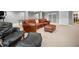 Finished basement features a spacious seating area with a large leather sofa and ottoman at 2144 Lamplight Dr, Marietta, GA 30062