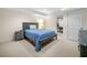 Spacious carpeted bedroom with a wooden framed bed and nightstand, with large windows and natural light at 2144 Lamplight Dr, Marietta, GA 30062
