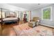 Spacious main bedroom featuring hardwood floors, sitting area with chair, and large windows at 2144 Lamplight Dr, Marietta, GA 30062