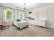 Cozy bedroom with large windows, a bed with decorative pillows, and modern shelving and dresser at 2144 Lamplight Dr, Marietta, GA 30062