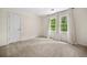Bright bedroom features neutral carpeting, fresh paint, two large windows, and a closet at 2144 Lamplight Dr, Marietta, GA 30062