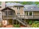 Spacious home exterior with a large deck, screened-in porch, and well-maintained landscaping at 2144 Lamplight Dr, Marietta, GA 30062