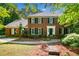 Charming two-story brick home with manicured lawn and mature trees creating a welcoming curb appeal at 2144 Lamplight Dr, Marietta, GA 30062