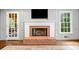 Detailed fireplace with brick hearth in a living room with hardwood floors and view to outdoor at 2144 Lamplight Dr, Marietta, GA 30062