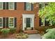 Inviting brick home featuring a classic front door with decorative accents and lush landscaping at 2144 Lamplight Dr, Marietta, GA 30062