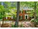 Traditional brick home with a well-manicured lawn and mature trees at 2144 Lamplight Dr, Marietta, GA 30062