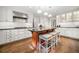 Bright kitchen featuring white cabinets, stainless appliances, island with seating, and hardwood floors at 2144 Lamplight Dr, Marietta, GA 30062