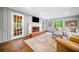 Cozy living room featuring a fireplace, hardwood floors, and access to an outdoor space, perfect for relaxing at 2144 Lamplight Dr, Marietta, GA 30062