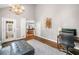 Bright living room featuring hardwood floors, high ceilings, chandelier, and adjacent kitchen at 2144 Lamplight Dr, Marietta, GA 30062