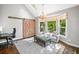Sunlit living room with vaulted ceiling, stylish chandelier, barn door, and multiple seating options at 2144 Lamplight Dr, Marietta, GA 30062