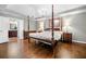 Beautiful primary bedroom with four-poster bed, hardwood floors, and ensuite bathroom at 2144 Lamplight Dr, Marietta, GA 30062