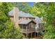 Charming home exterior featuring a screened porch, deck, and private backyard surrounded by lush greenery at 2144 Lamplight Dr, Marietta, GA 30062