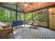 Inviting screened porch with vaulted wood ceiling and comfortable seating overlooking lush greenery at 2144 Lamplight Dr, Marietta, GA 30062