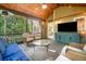 Relaxing screened porch featuring wood ceiling, comfortable seating, and views of lush greenery at 2144 Lamplight Dr, Marietta, GA 30062
