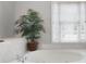 Close up of soaking tub with spa jets and a large window that brings in natural light at 5042 Southland Dr, Woodstock, GA 30188