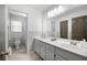 Well-lit bathroom featuring double sinks, vanity with storage, and a separate toilet and shower area at 5042 Southland Dr, Woodstock, GA 30188