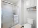 Clean bathroom featuring a glass shower, toilet, and storage cabinet at 5042 Southland Dr, Woodstock, GA 30188