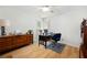 Bright bedroom with wood floors, a ceiling fan, and two windows providing natural light at 5042 Southland Dr, Woodstock, GA 30188