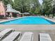 Community pool with lounge chairs and tables at 5042 Southland Dr, Woodstock, GA 30188