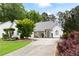 Charming home featuring a stone and siding facade, well-manicured lawn, and a welcoming driveway at 5042 Southland Dr, Woodstock, GA 30188