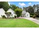 Charming single-story home boasts lush landscaping, a well-manicured lawn, and a welcoming facade at 5042 Southland Dr, Woodstock, GA 30188