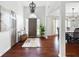 Inviting foyer with hardwood floors, high ceilings, and a view into the dining room at 5042 Southland Dr, Woodstock, GA 30188