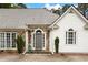 Close-up of the front entrance of the house, featuring stone accents and an arched doorway at 5042 Southland Dr, Woodstock, GA 30188