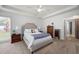 Bright and airy main bedroom featuring a tray ceiling and carpet at 5042 Southland Dr, Woodstock, GA 30188