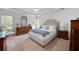 Serene primary bedroom with a tray ceiling, ample natural light, and neutral tones at 5042 Southland Dr, Woodstock, GA 30188