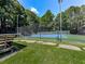 Community tennis court with benches and shade at 5042 Southland Dr, Woodstock, GA 30188