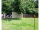 Spacious backyard featuring a storage shed and a lush lawn, perfect for outdoor activities at 6030 Pattingham Dr, Roswell, GA 30075