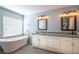Bright bathroom featuring a soaking tub, double sinks and granite countertop at 6030 Pattingham Dr, Roswell, GA 30075