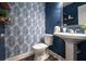 Stylish half bathroom with blue walls, patterned wallpaper, and pedestal sink at 6030 Pattingham Dr, Roswell, GA 30075
