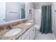 Bathroom featuring dual sinks, granite countertop, and shower with tub at 6030 Pattingham Dr, Roswell, GA 30075
