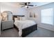 Comfortable bedroom with a full size bed, neutral colors, and natural light at 6030 Pattingham Dr, Roswell, GA 30075