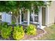 Charming front porch with chairs provides a welcoming entrance, complemented by manicured landscaping at 6030 Pattingham Dr, Roswell, GA 30075