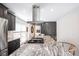 Kitchen featuring a center island with granite counters, gas cooktop, and ample storage space at 6030 Pattingham Dr, Roswell, GA 30075