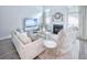 Inviting living room with large windows, fireplace, neutral furniture, and a stylish decor at 6030 Pattingham Dr, Roswell, GA 30075