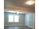 Open living area with modern flooring, ceiling fan, and large windows for natural light at 1131 Indale Sw Pl, Atlanta, GA 30310